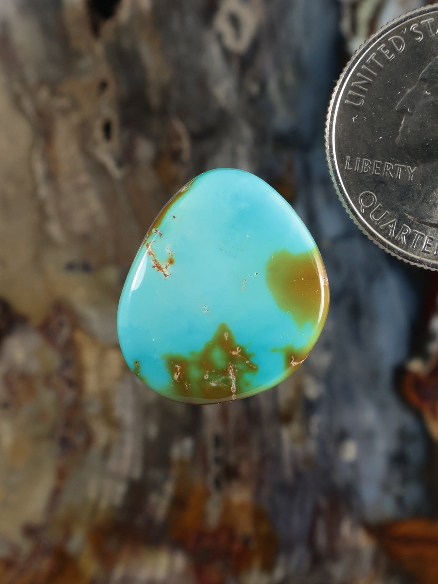 Turquoise cabochon gemstone, teardrop oval with warm gold-toned matrix