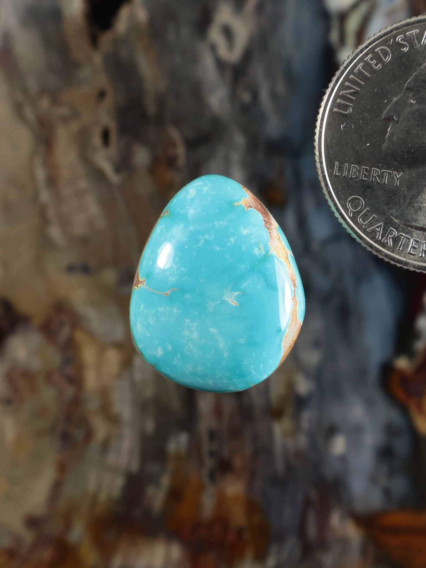Turquoise oval cabochon with natural white veining, polished gemstone