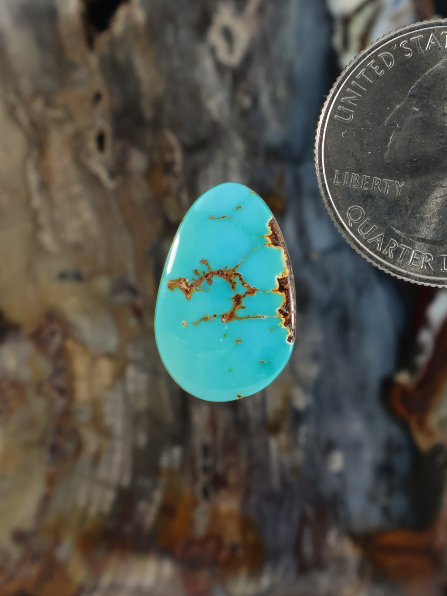 Turquoise oval cabochon with brown matrix and small natural specks