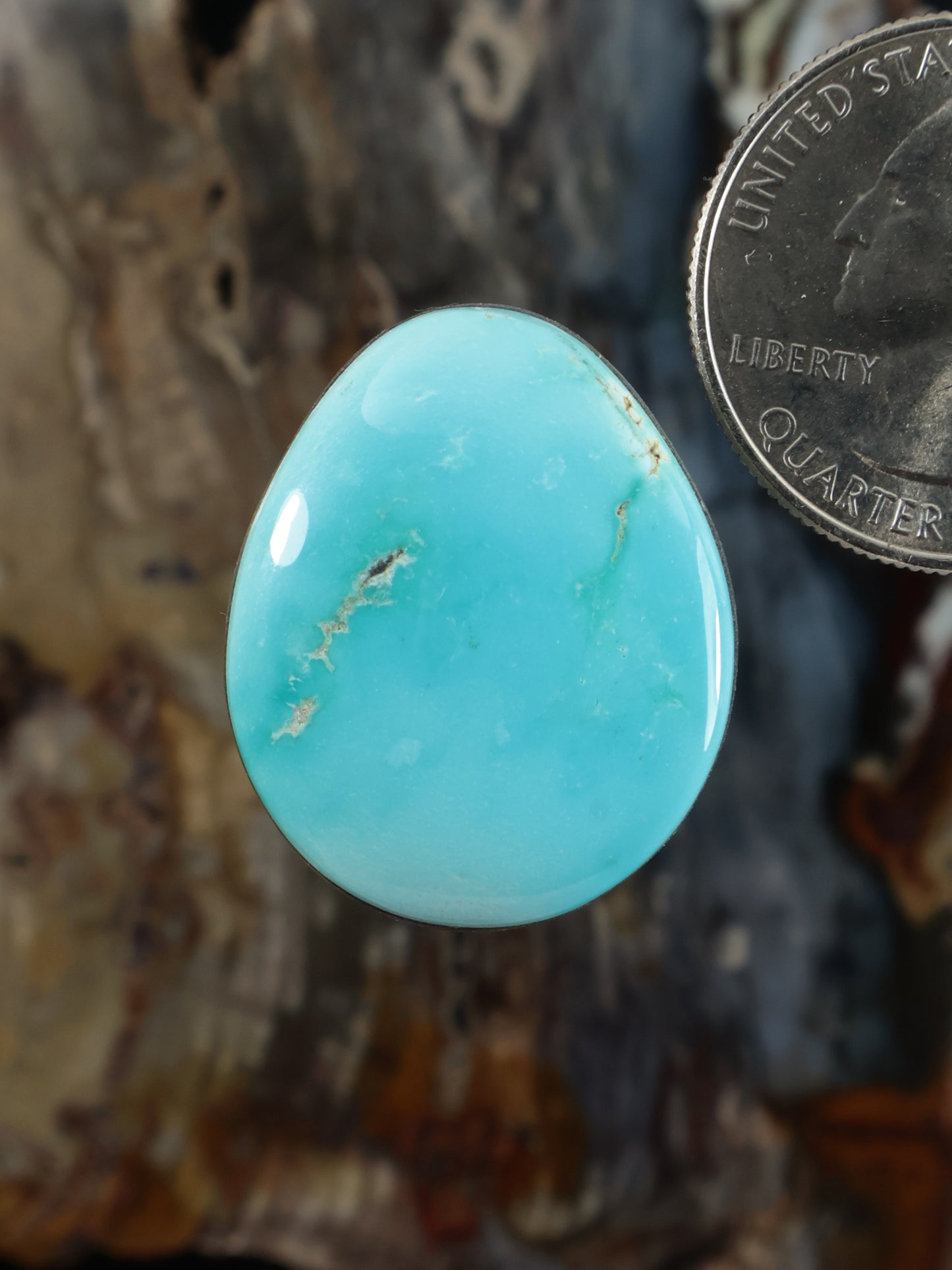 Oval turquoise cabochon gemstone with smooth polished surface
