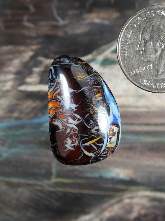 Yowah boulder opal cabochon N738, rounded oval with glossy blue edge and dark red pattern
