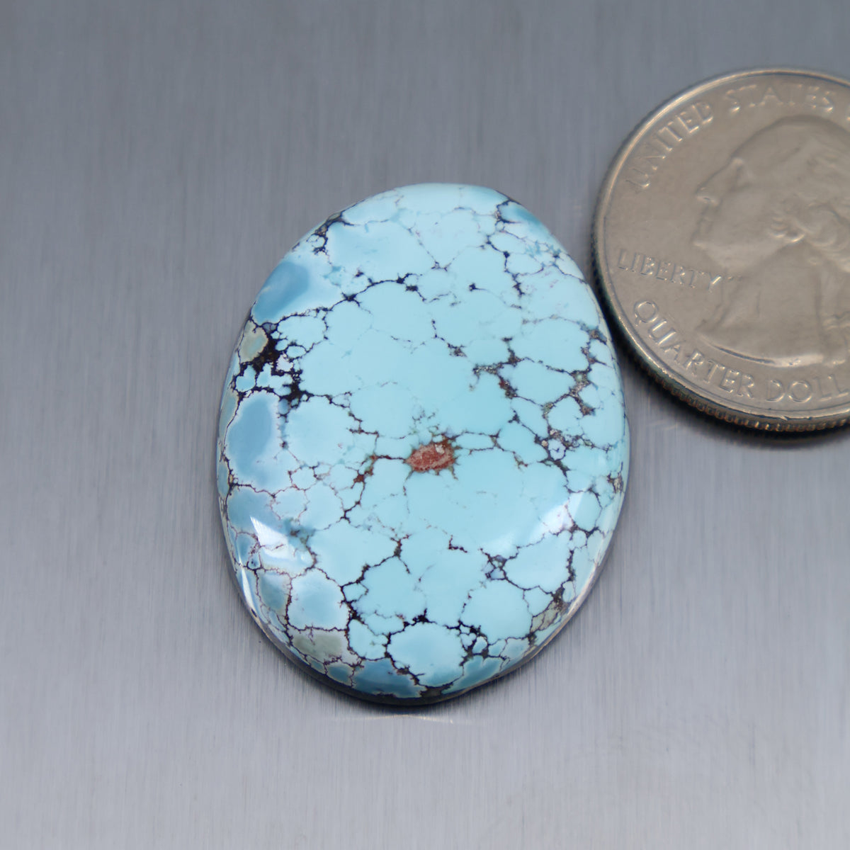 Light blue turquoise cabochon with black web veining, oval gemstone stone