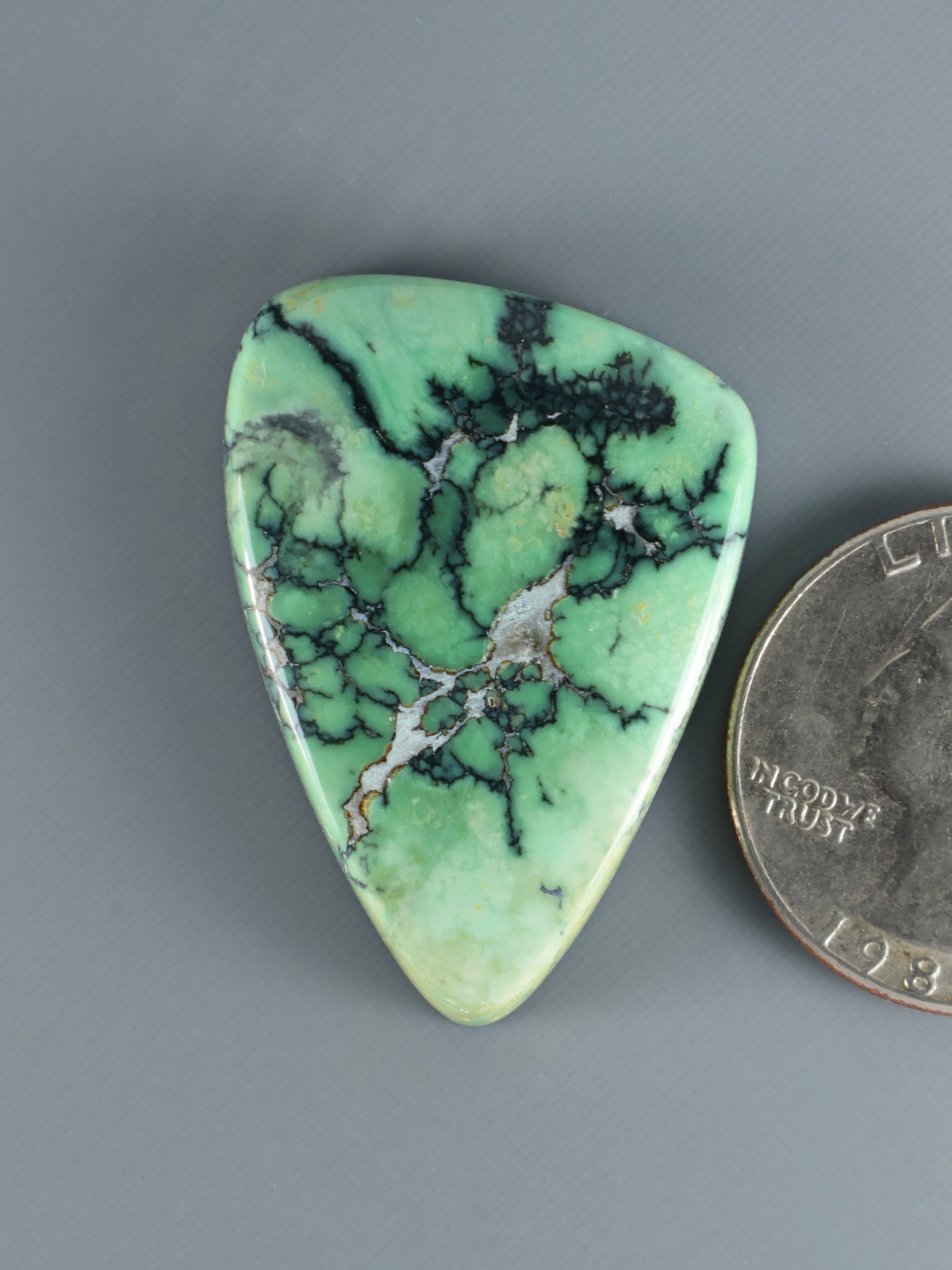 Turquoise green variscite cabochon with dark webbed matrix, teardrop shape