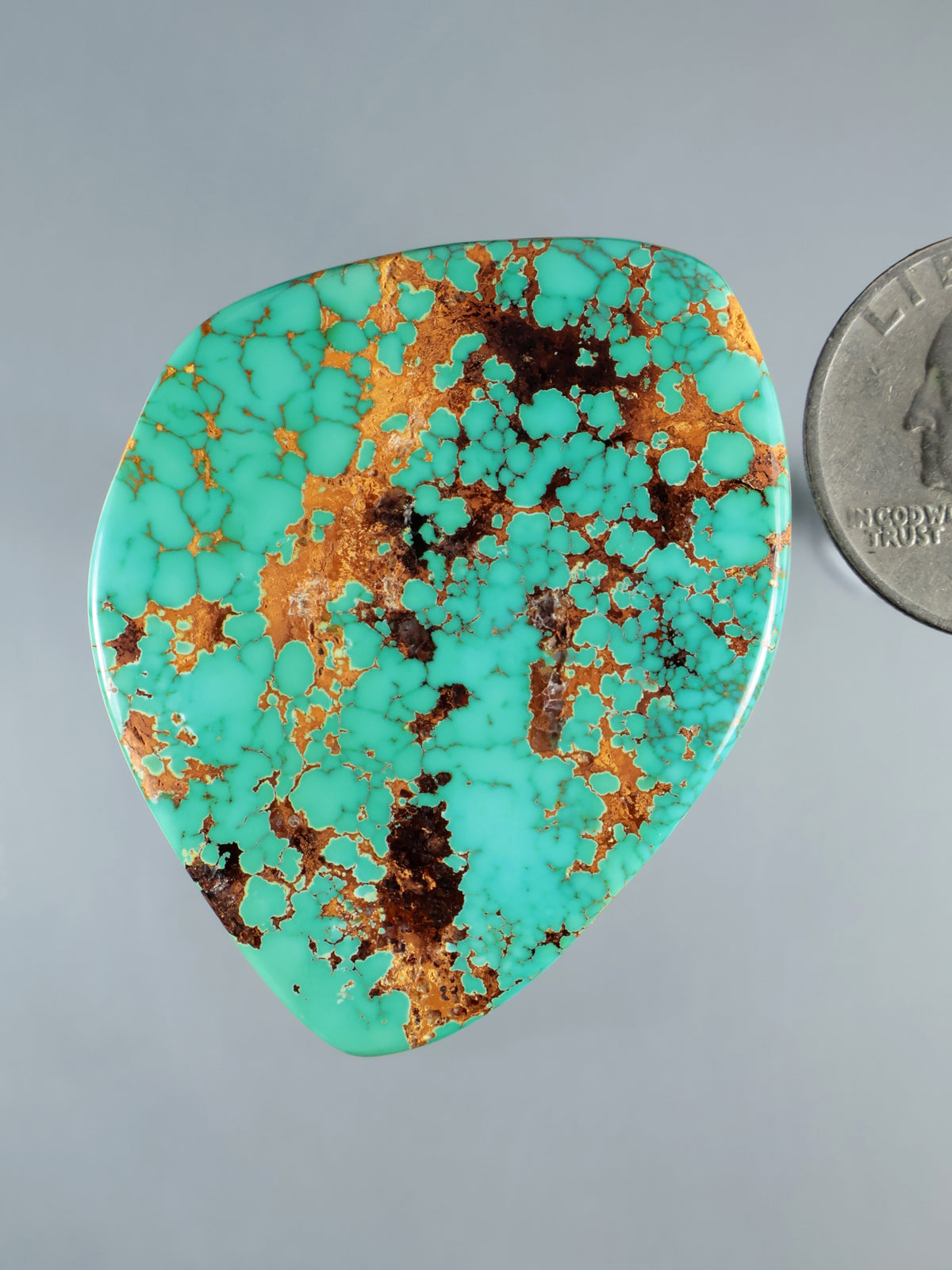 Turquoise cabochon gemstone teardrop with golden-brown matrix veining
