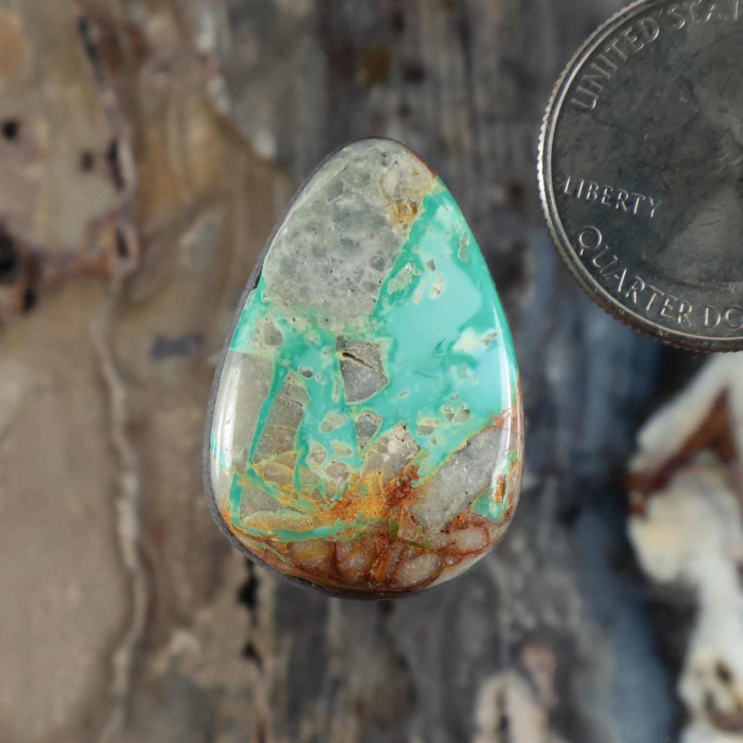 Royston turquoise cabochon teardrop gemstone with green-blue surface and brown matrix