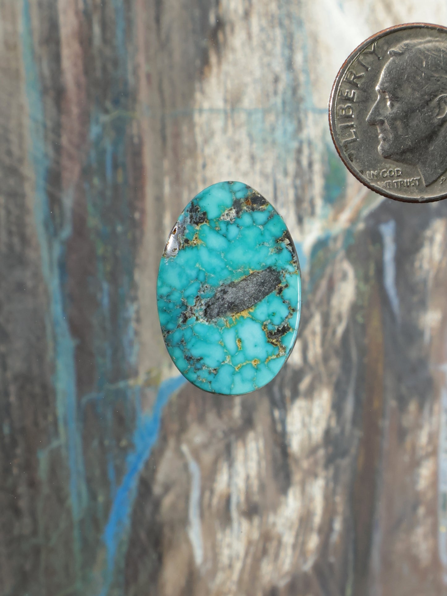 Oval turquoise cabochon gemstone with gold matrix veins