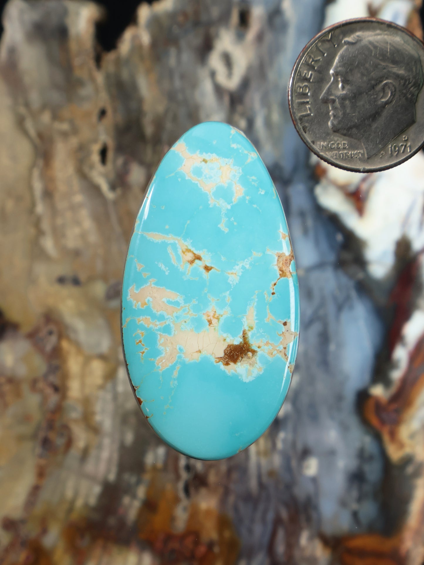 Oval turquoise cabochon with natural gold-brown veining