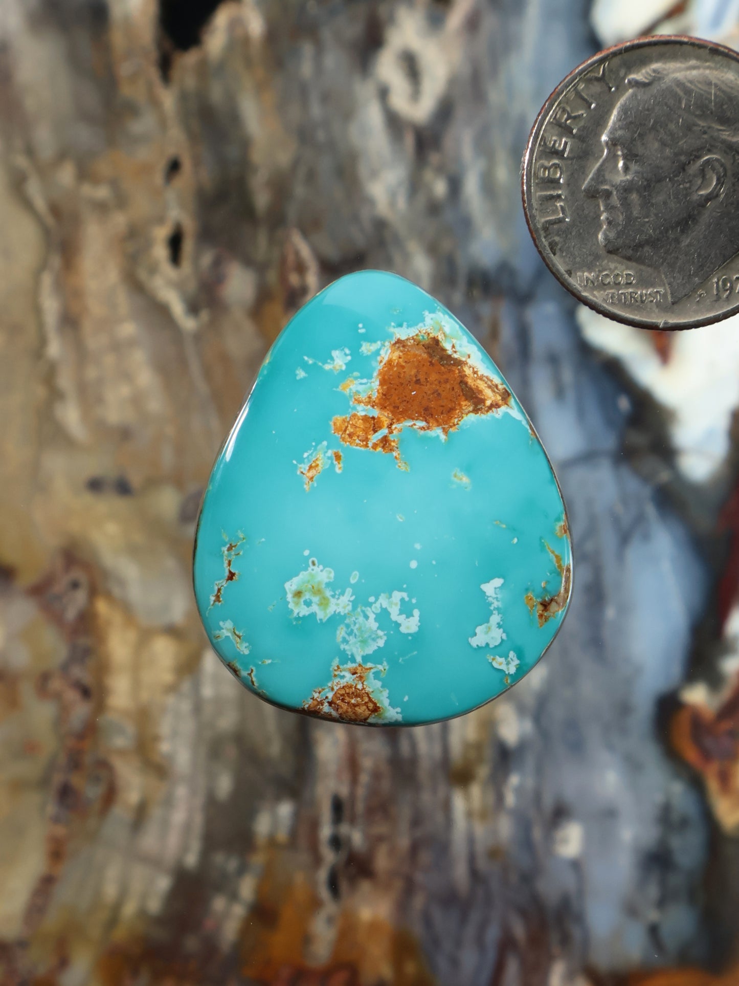 Turquoise teardrop cabochon with golden-brown matrix veining