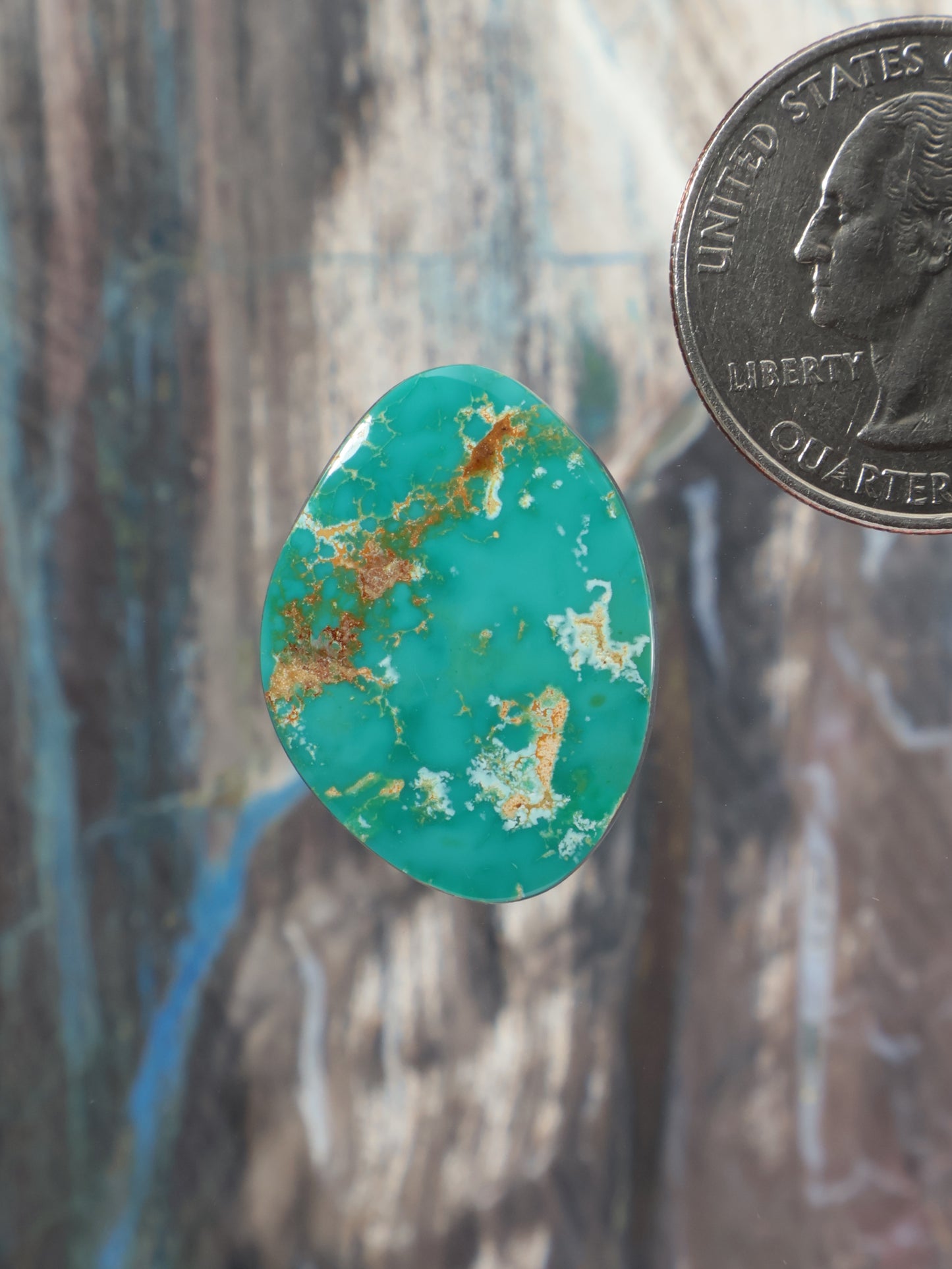 Turquoise teardrop cabochon with scattered gold matrix veining