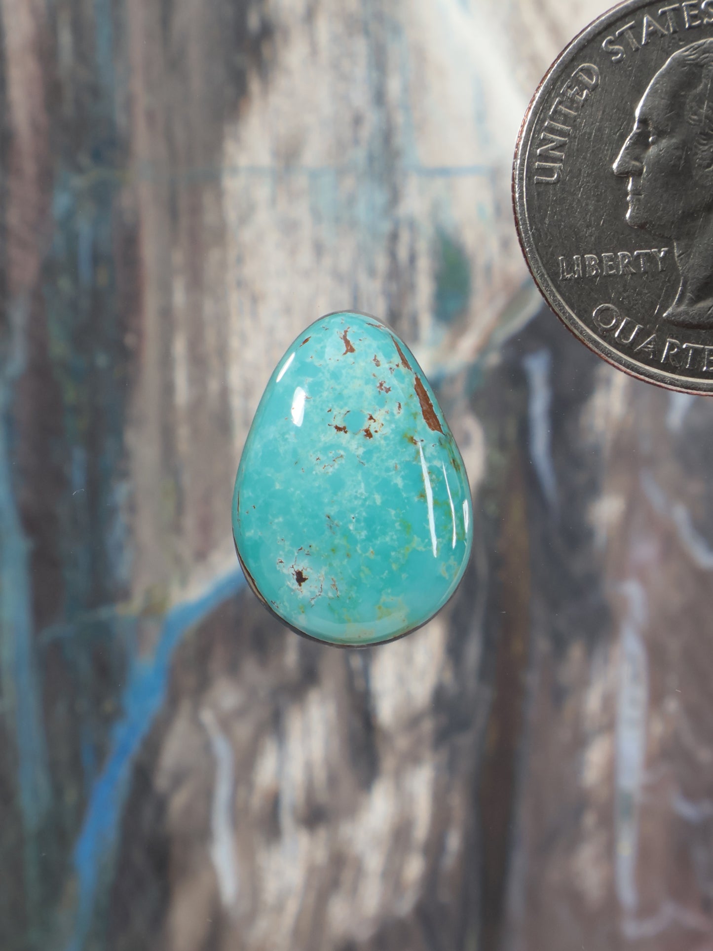 Turquoise oval cabochon gemstone with mottled matrix finish