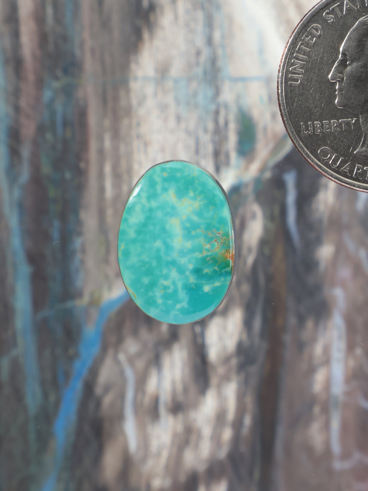 Oval turquoise cabochon gemstone with smooth polished surface