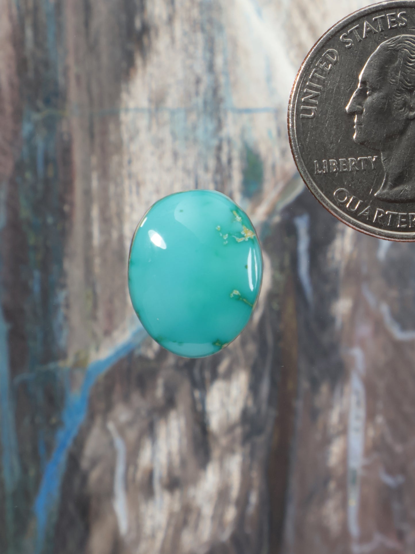 Turquoise blue oval cabochon gemstone with smooth glossy surface