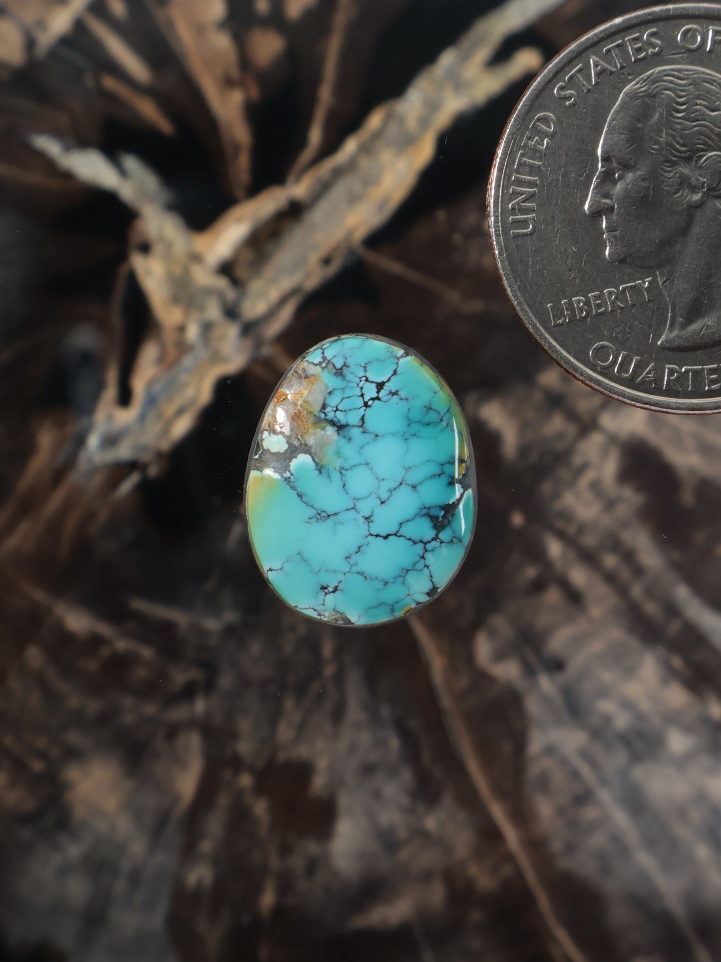 Round turquoise cabochon gemstone with blue-green matrix and polished surface