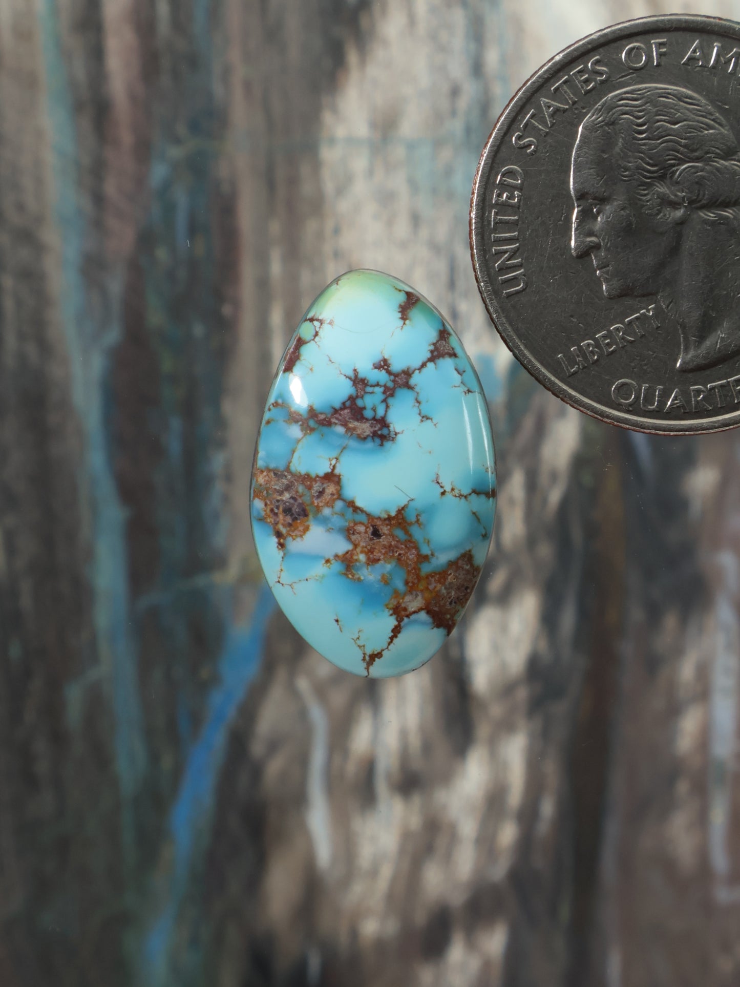 Turquoise oval cabochon gemstone with brown matrix veining
