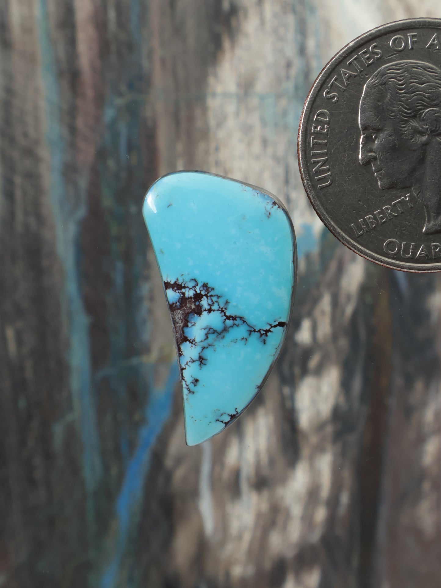 Light blue turquoise cabochon gemstone, teardrop shape with dark webbed veins