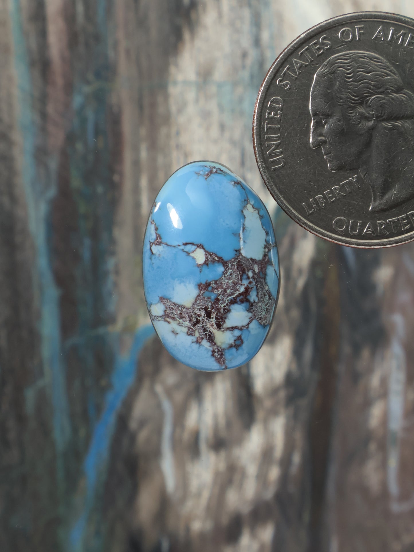Oval blue turquoise cabochon gemstone with natural matrix veining