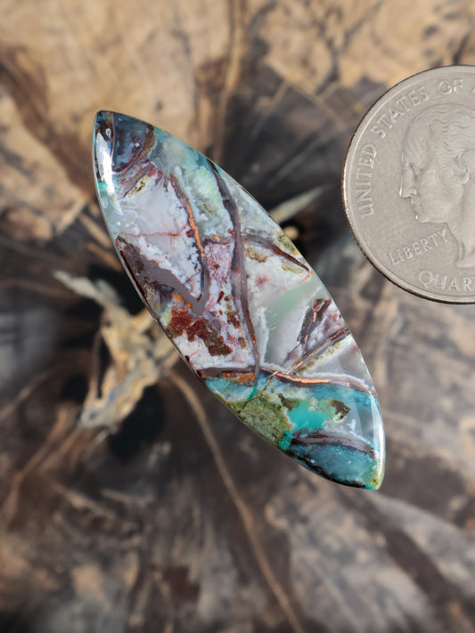Oval marquise cabochon gemstone with turquoise, green, and red veining, domed