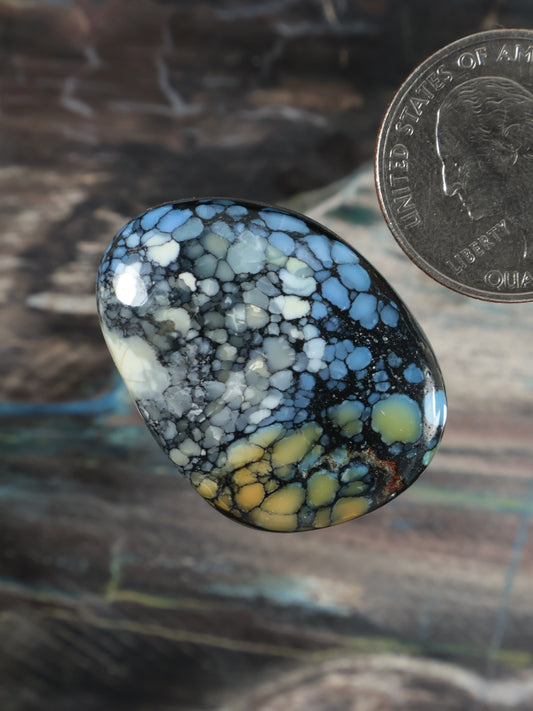 Dome oval blue cabochon with speckled white matrix and yellowish vein details