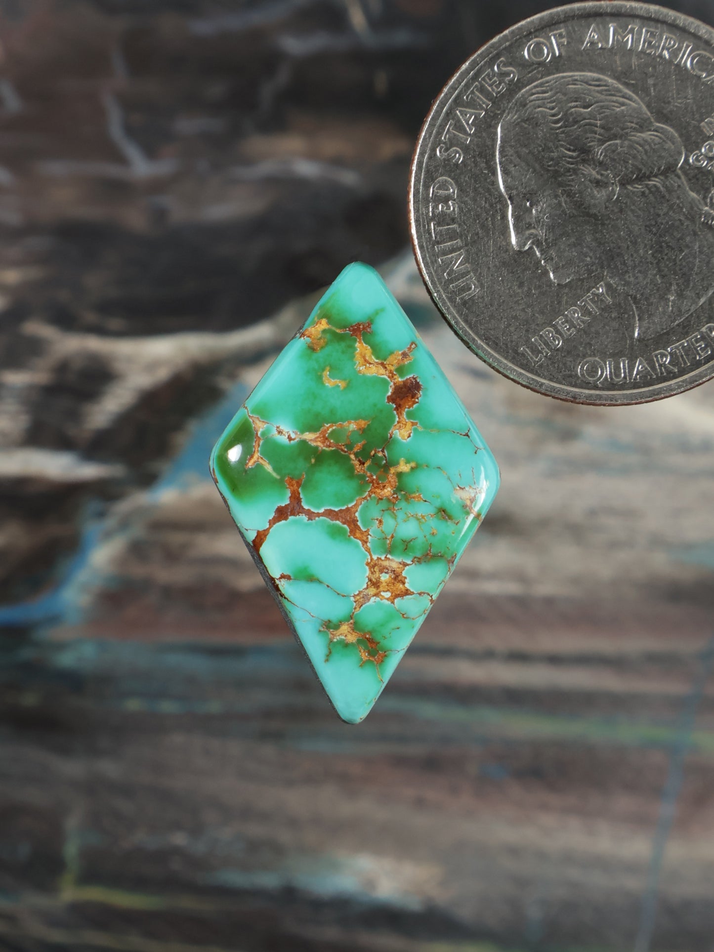 Teardrop turquoise cabochon gemstone with gold-brown matrix detail