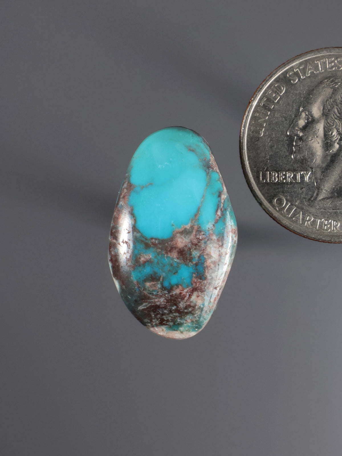 Turquoise cabochon gemstone, teardrop shape with brown matrix veining