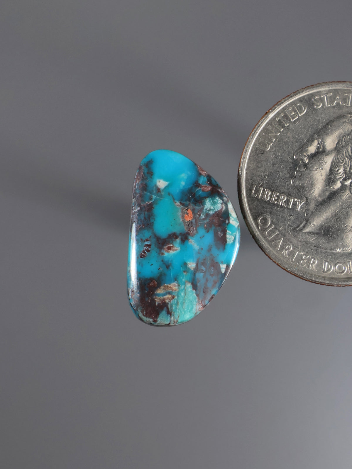 Turquoise cabochon gemstone with blue stone and dark natural matrix pattern
