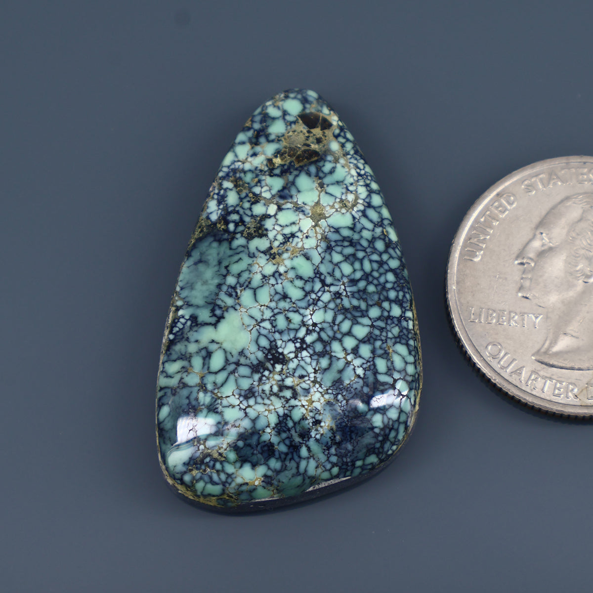 Teal and light-green variscite cabochon with web-like vein pattern, teardrop