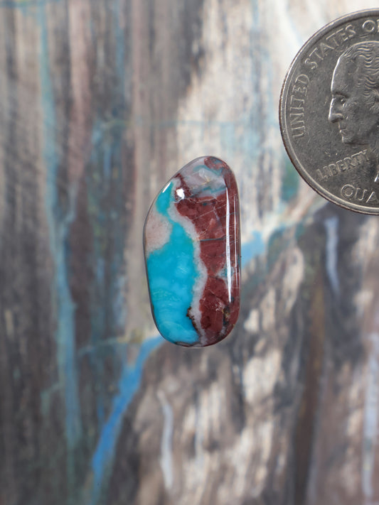 Bisbee turquoise cabochon oval with red-brown matrix stone detail