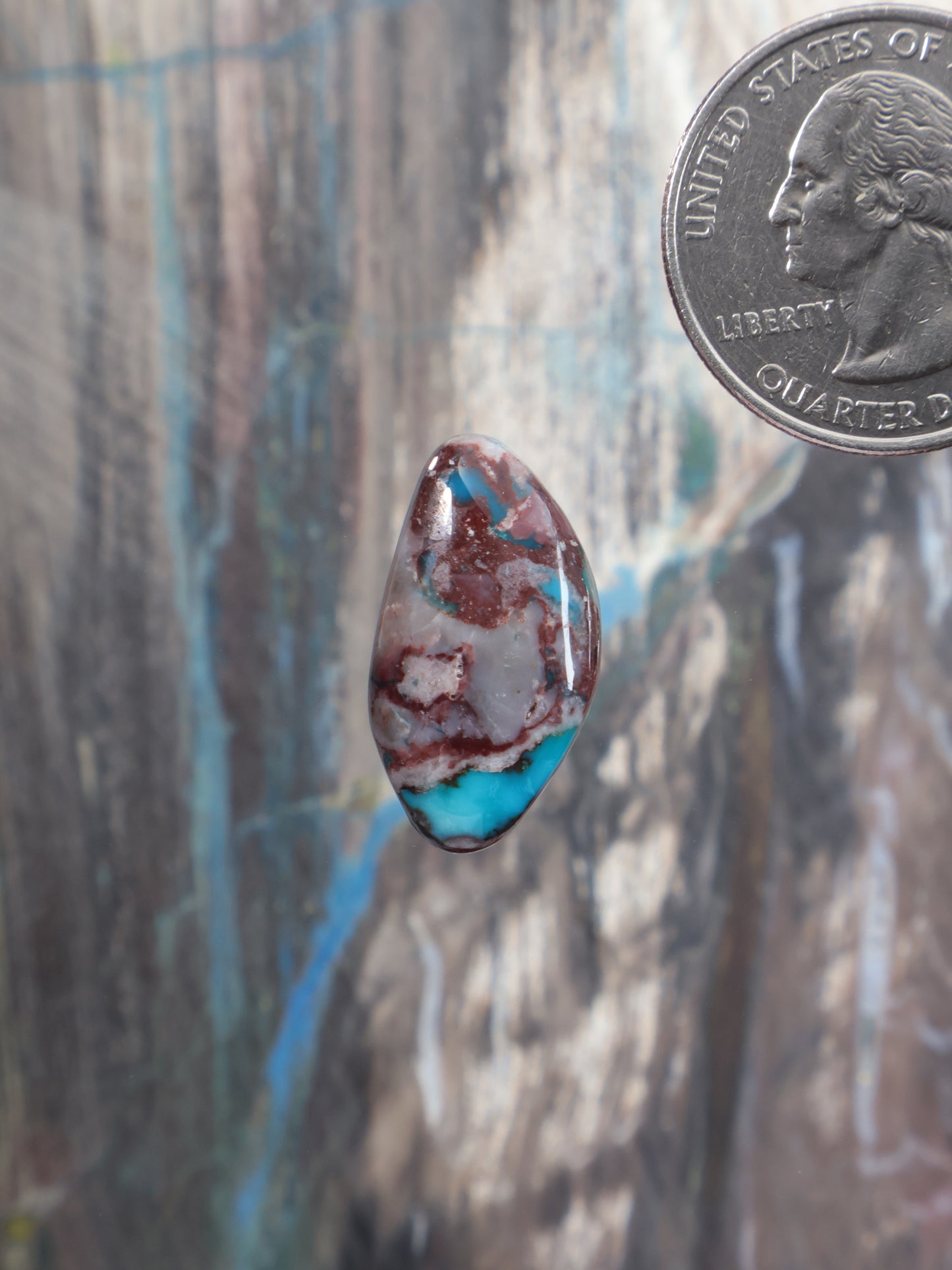Teardrop turquoise cabochon with blue and red stone matrix, polished