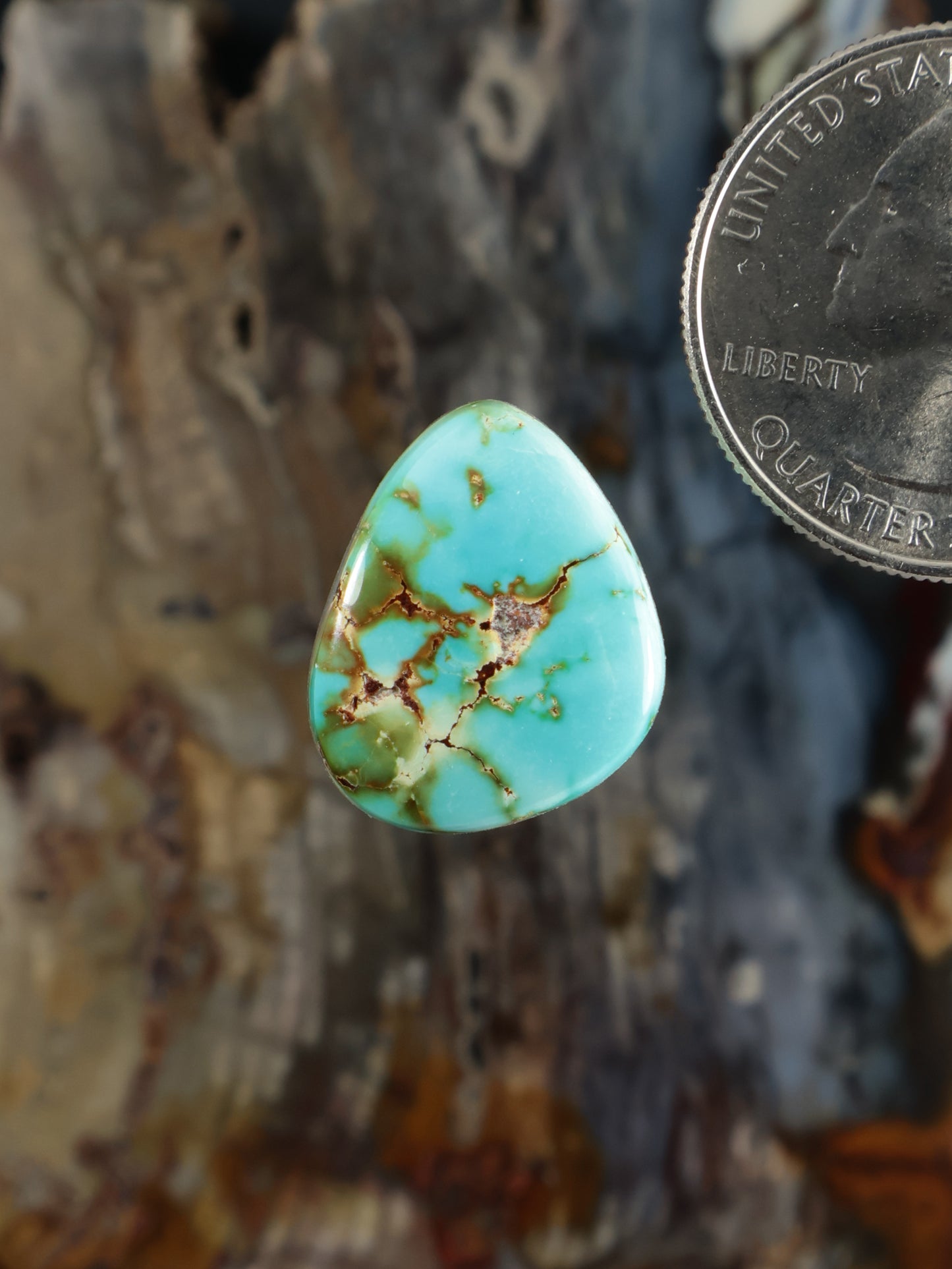 Teardrop turquoise cabochon gemstone with gold veining detail
