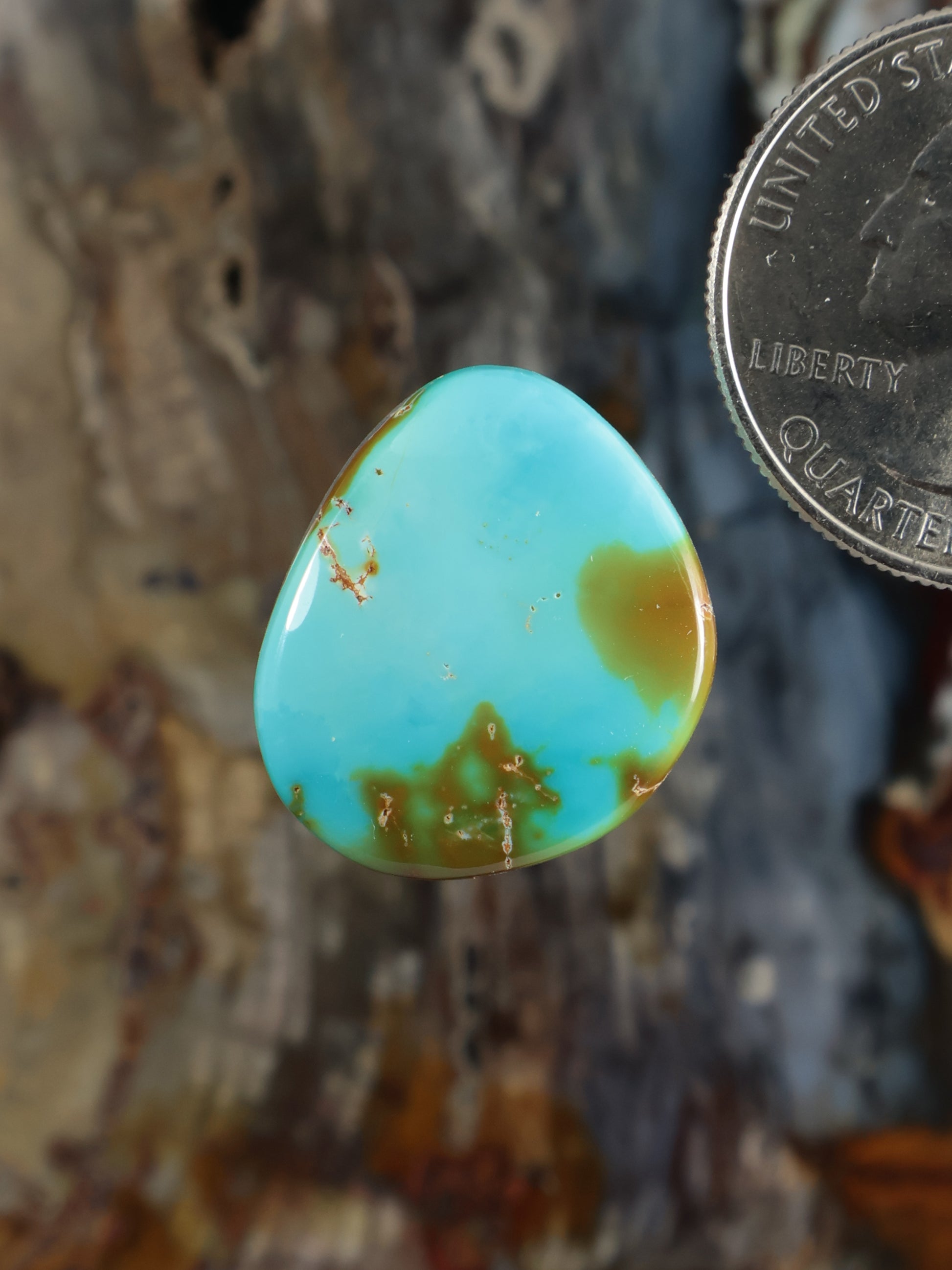Turquoise cabochon gemstone, teardrop oval with warm gold-toned matrix