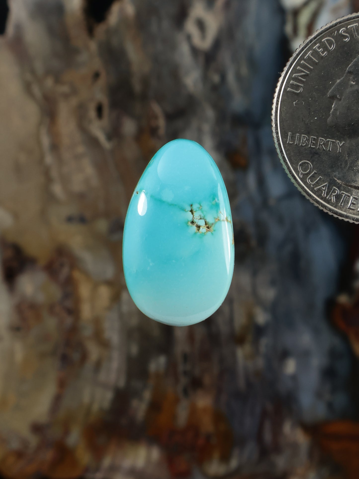 Turquoise oval cabochon gemstone with gold matrix veining