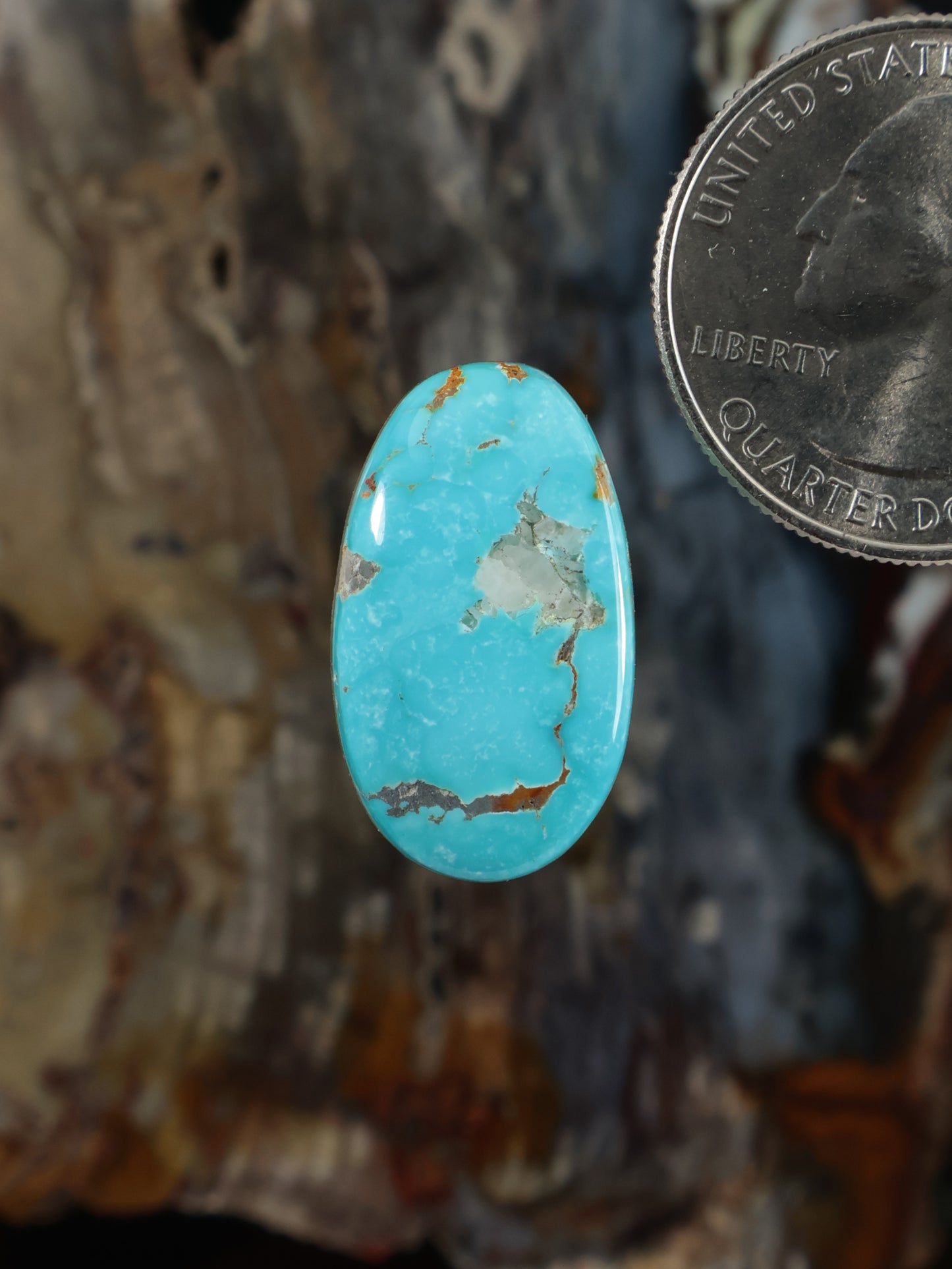 Oval turquoise cabochon gemstone with natural brown matrix inclusions