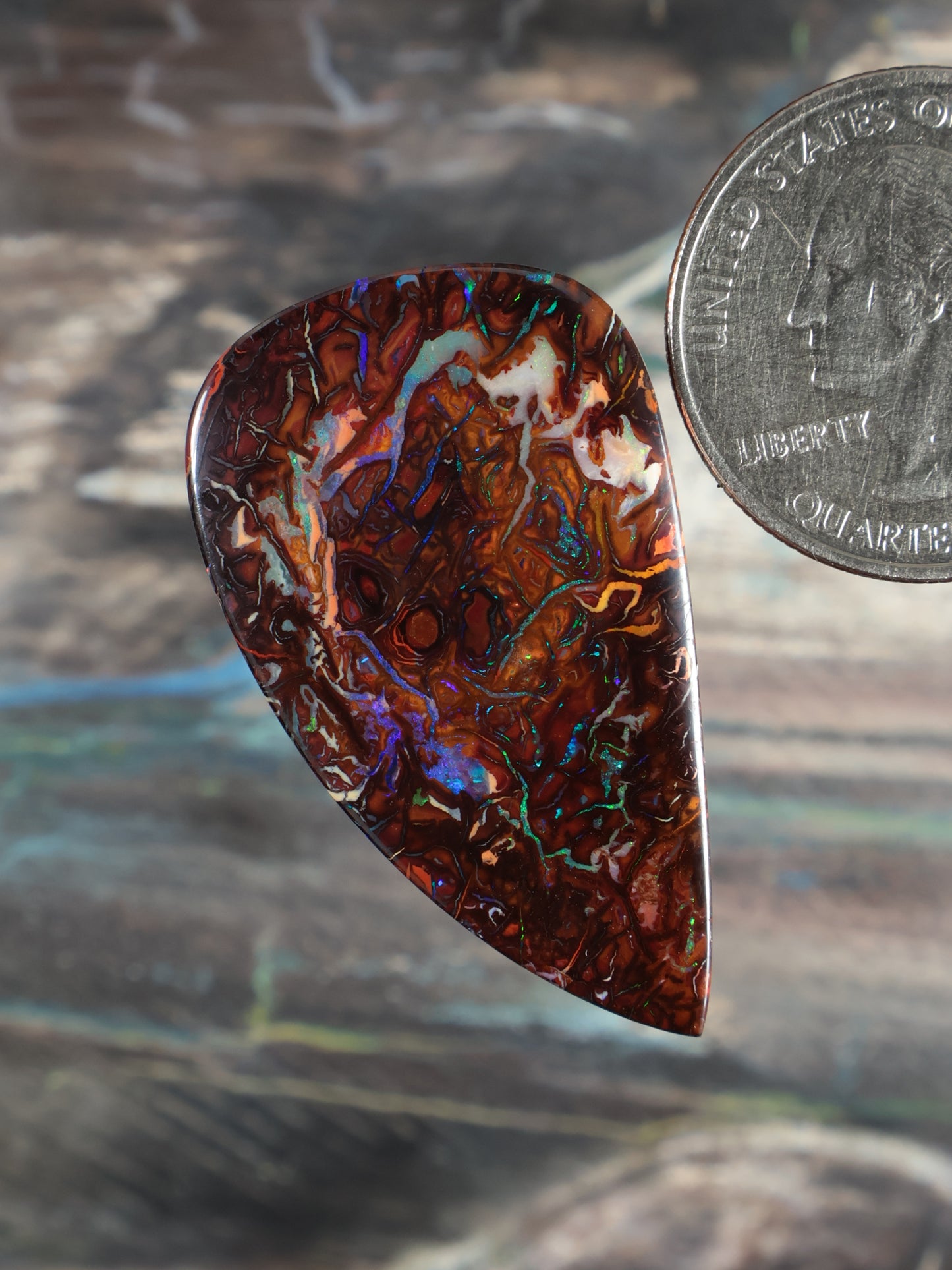 Yowah Boulder Opal cabochon, teardrop shape, dark red-brown with blue-green flashes