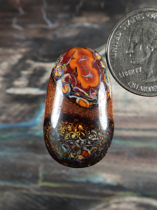 Multicolor boulder opal cabochon, oval dome with orange, blue, green patterns