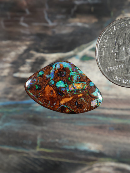 Opal cabochon triangular with brown matrix and bright green-blue opal areas