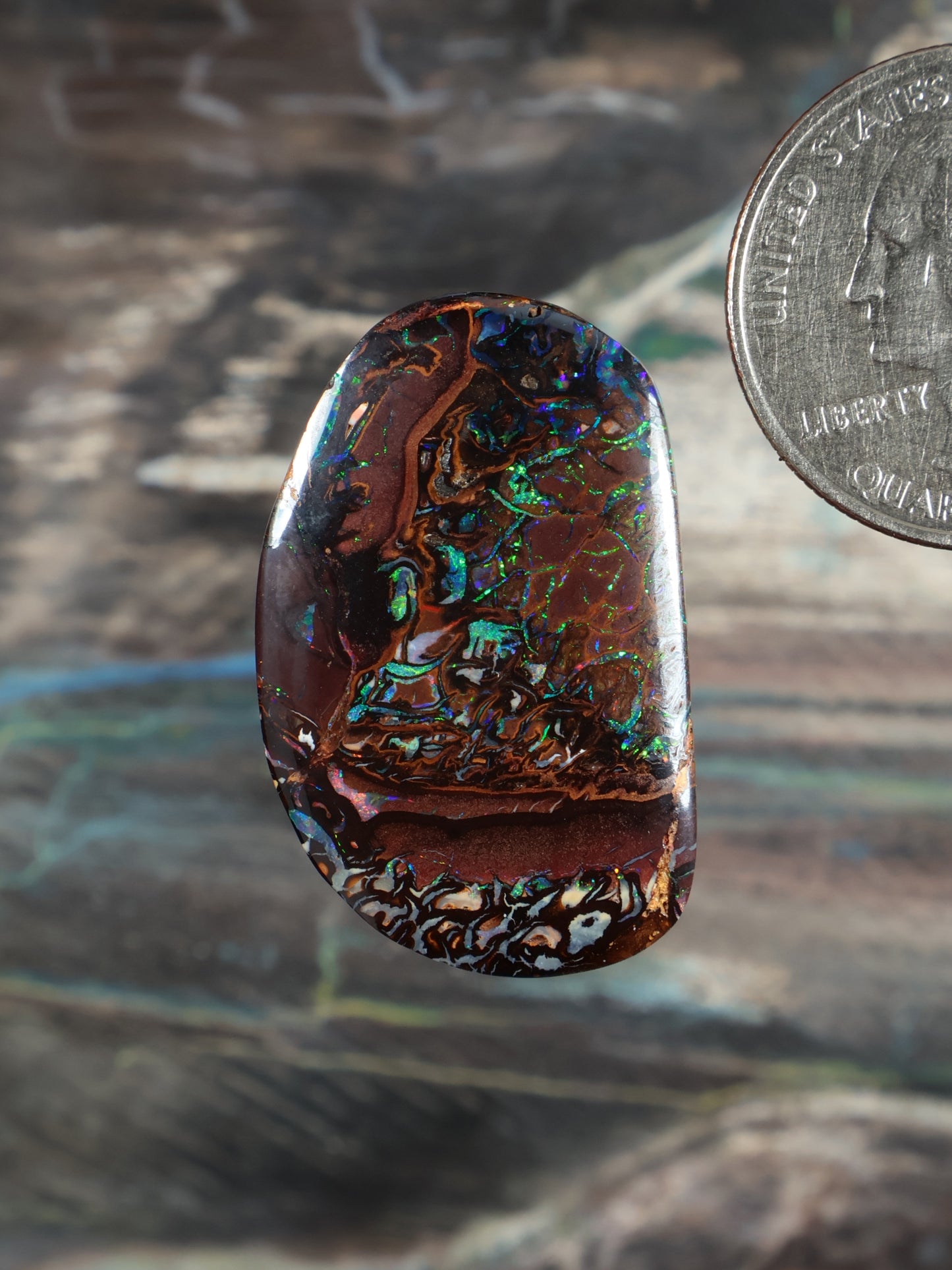 Yowah Boulder opal cabochon, dark bown with blue-green iridescent swirls, oval