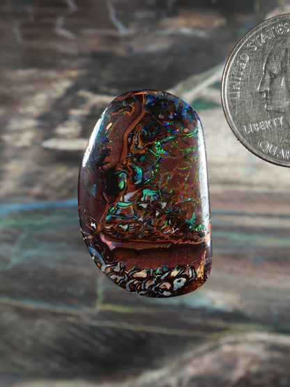 Yowah Boulder opal cabochon, dark bown with blue-green iridescent swirls, oval