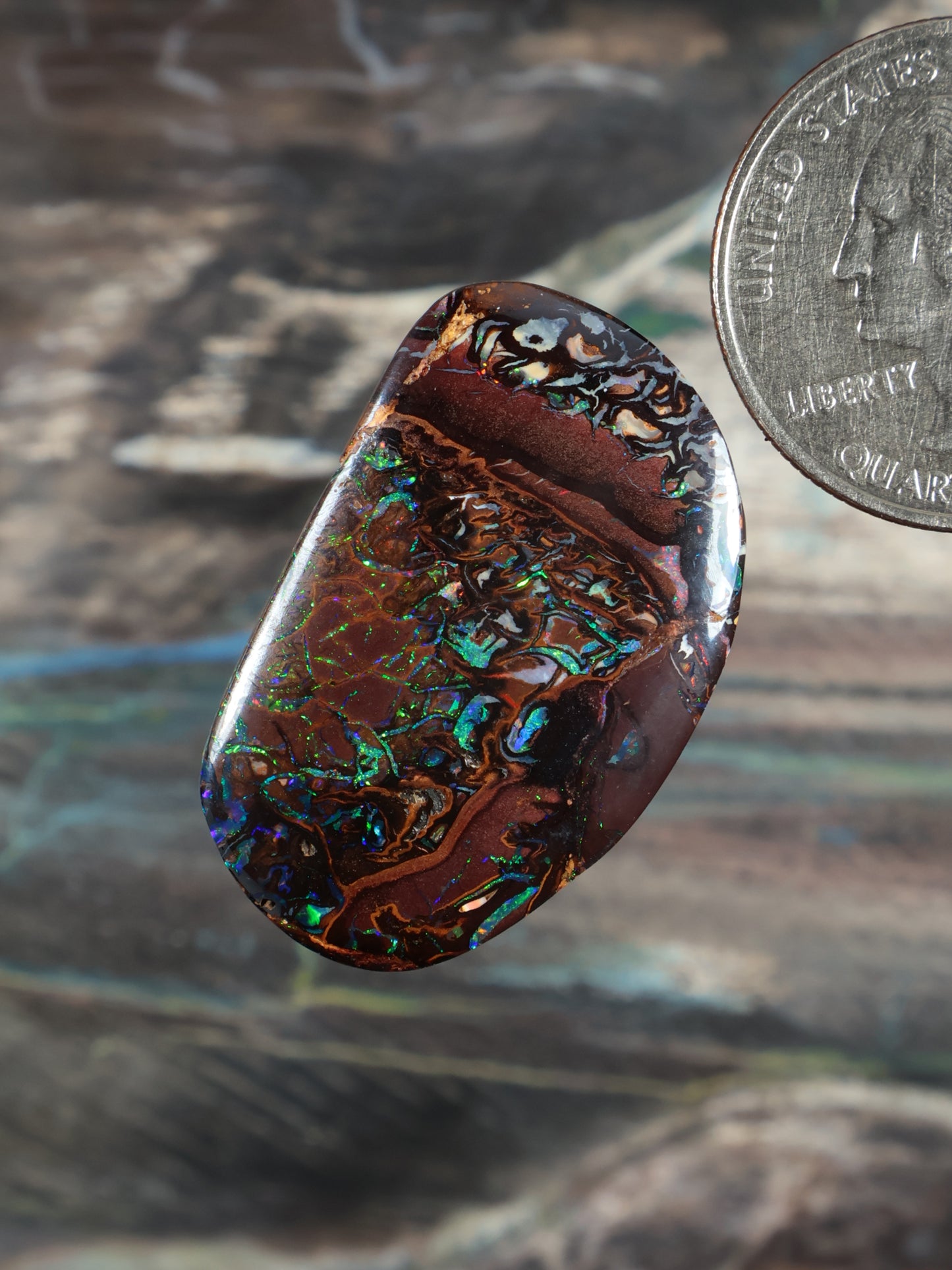 Yowah Boulder opal cabochon, brown with blue-green iridescent patterns, oval