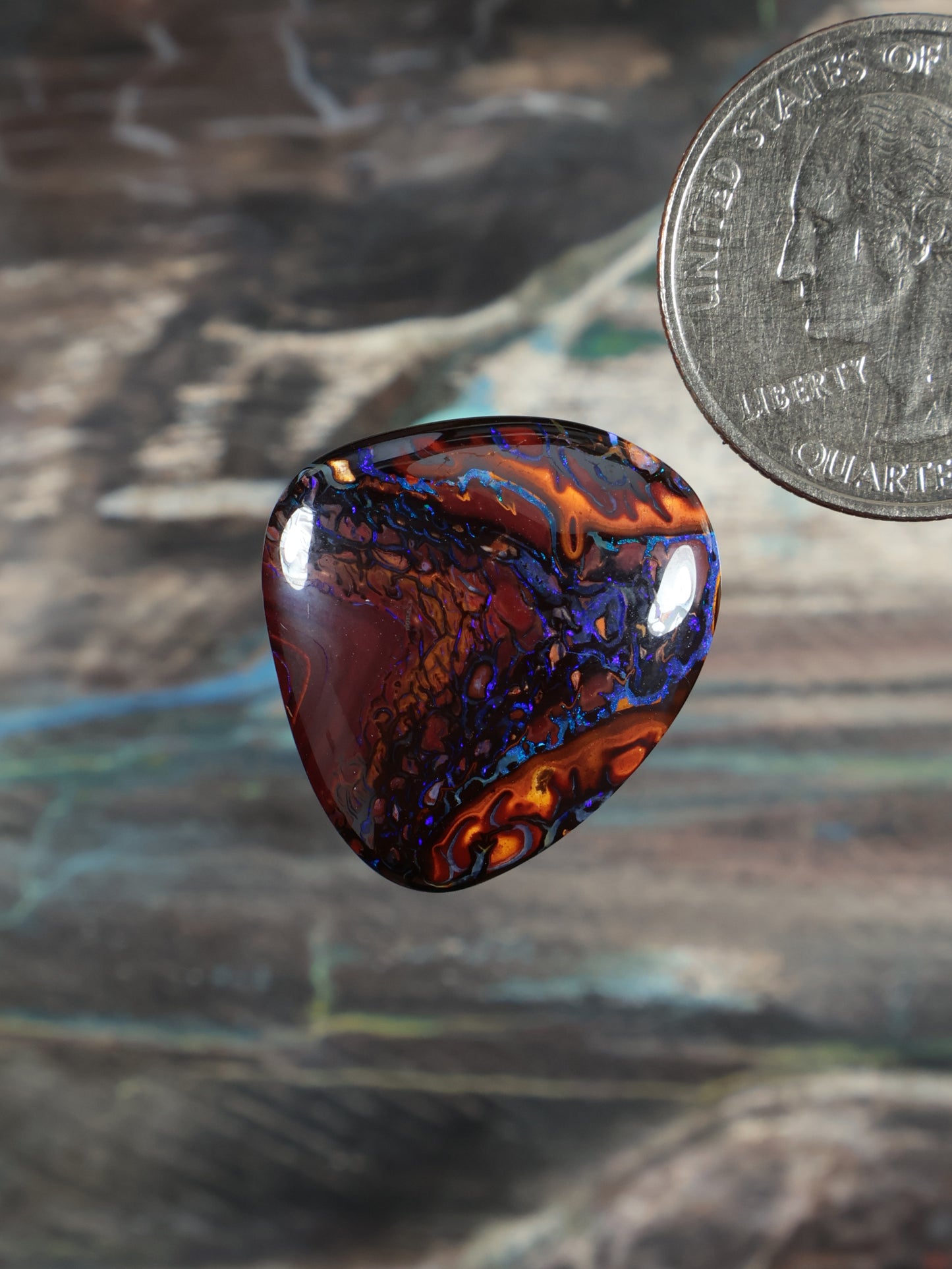 Yowah boulder opal cabochon, dark red and blue swirl pattern, polished teardrop