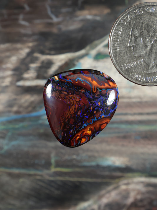 Yowah boulder opal cabochon, dark red and blue swirl pattern, polished teardrop