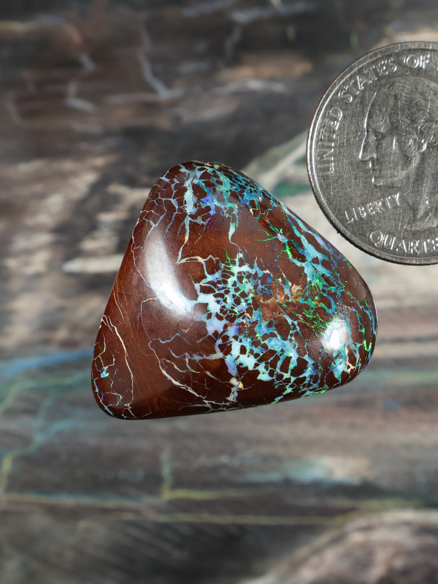 Opal boulder cabochon, brown with blue-green patchy matrix, teardrop shape.