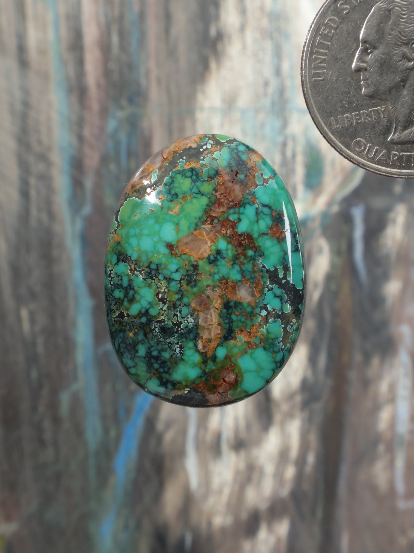 Turquoise cabochon gemstone with mottled matrix veining, oval shape