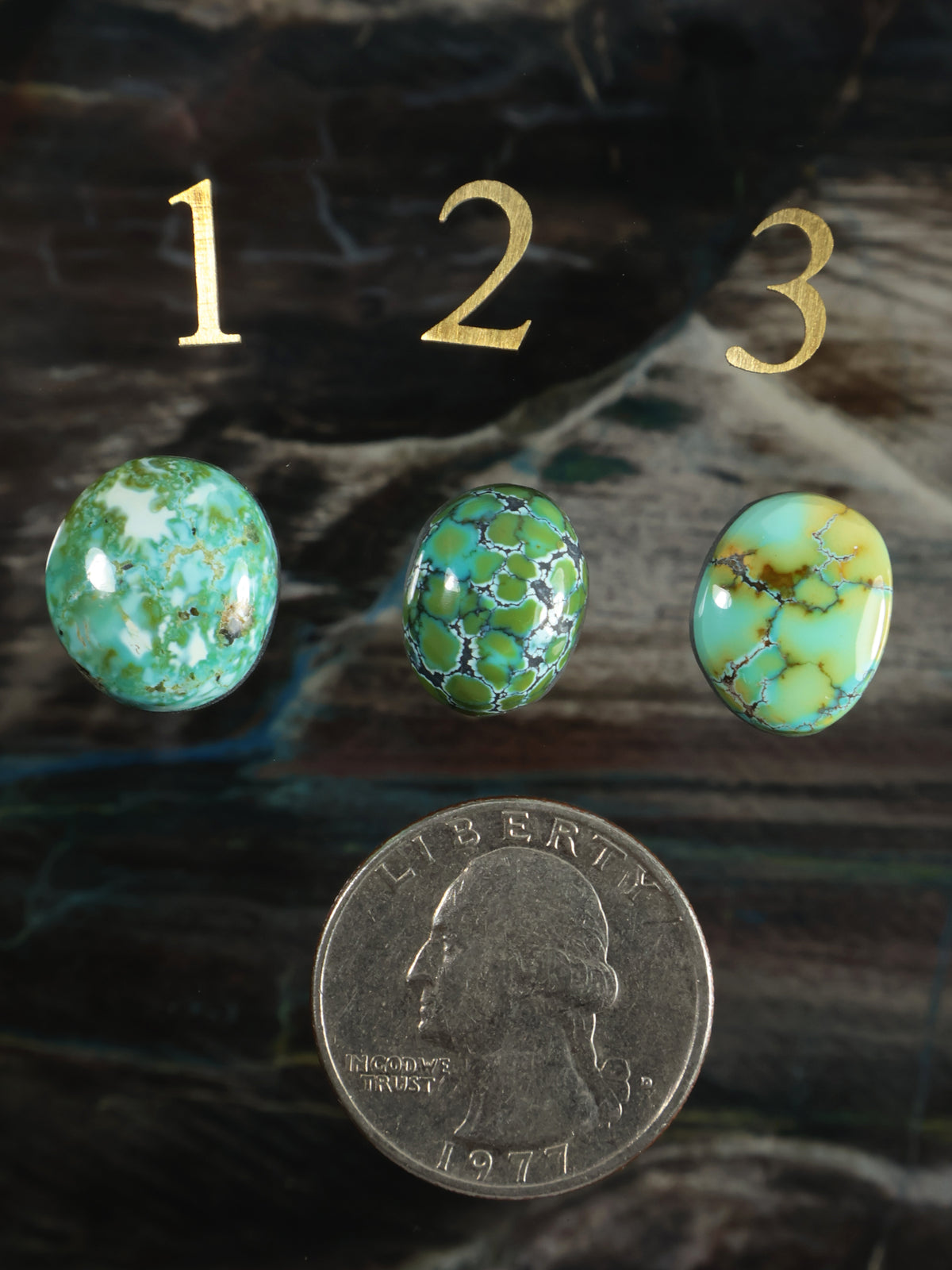Set of three green and turquoise cabochon gemstones with polished oval shapes