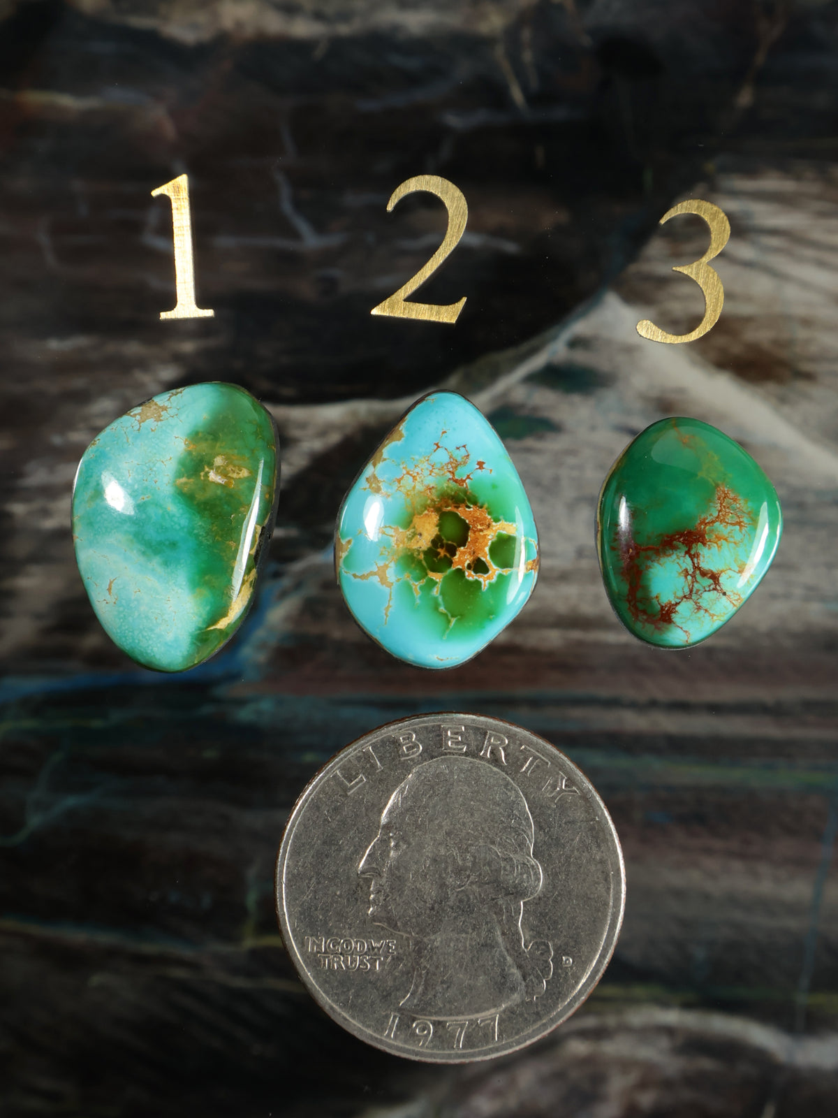 Set of three green turquoise teardrop cabochon stones with gold-speckled pattern