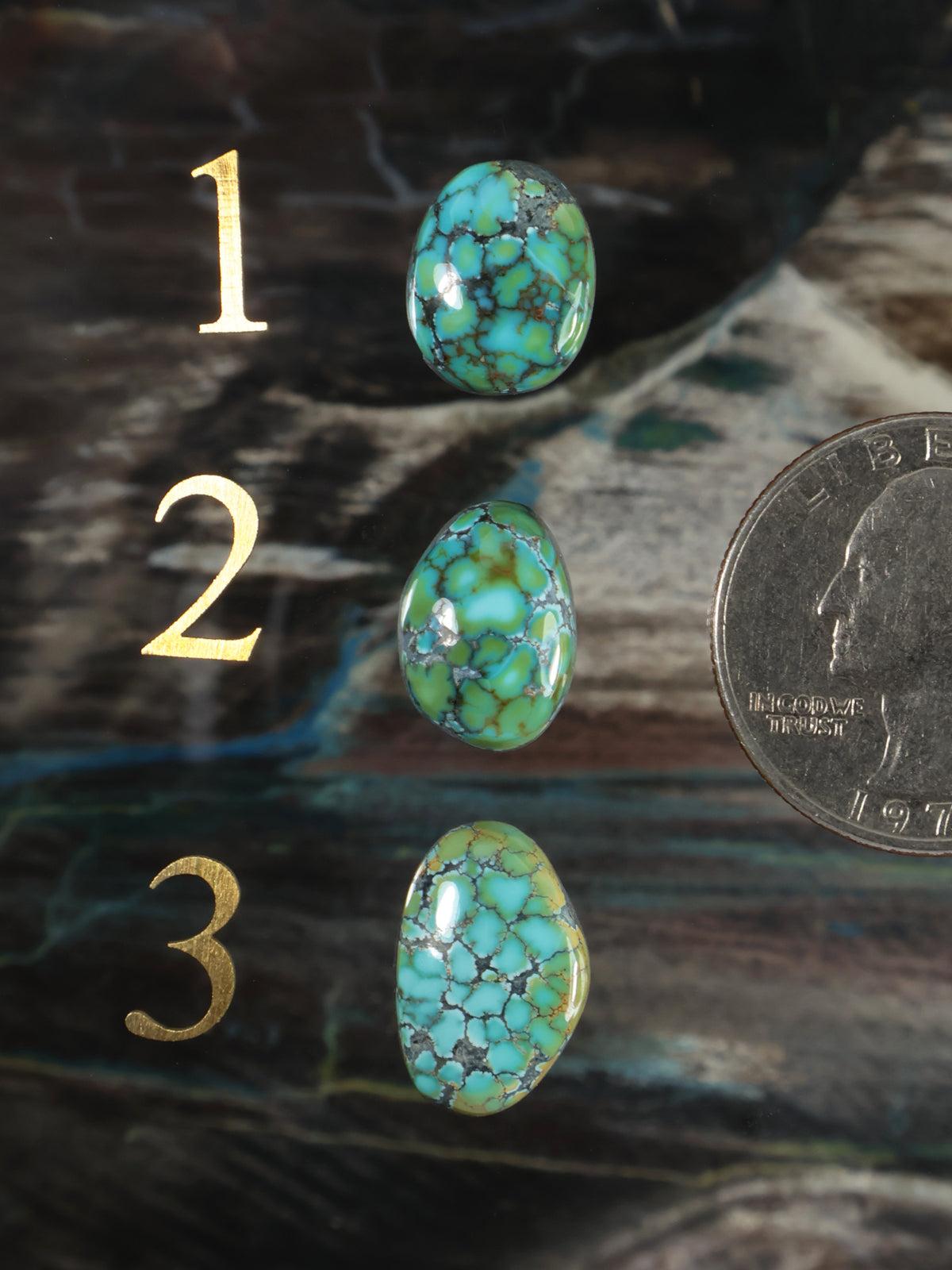 Blue-green turquoise oval cabochon gemstone, three stones with veined matrix