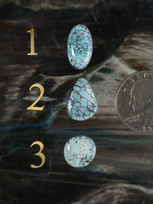 Turquoise oval cabochon gemstones, blue stone with white web pattern, three pieces