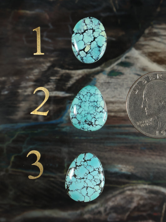 Turquoise oval gemstone cabochons set, three pieces with white veining