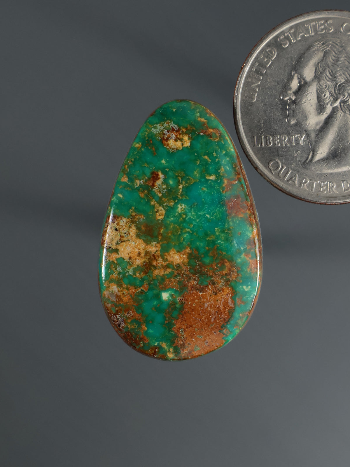 Teardrop cabochon gemstone with green turquoise and brown matrix