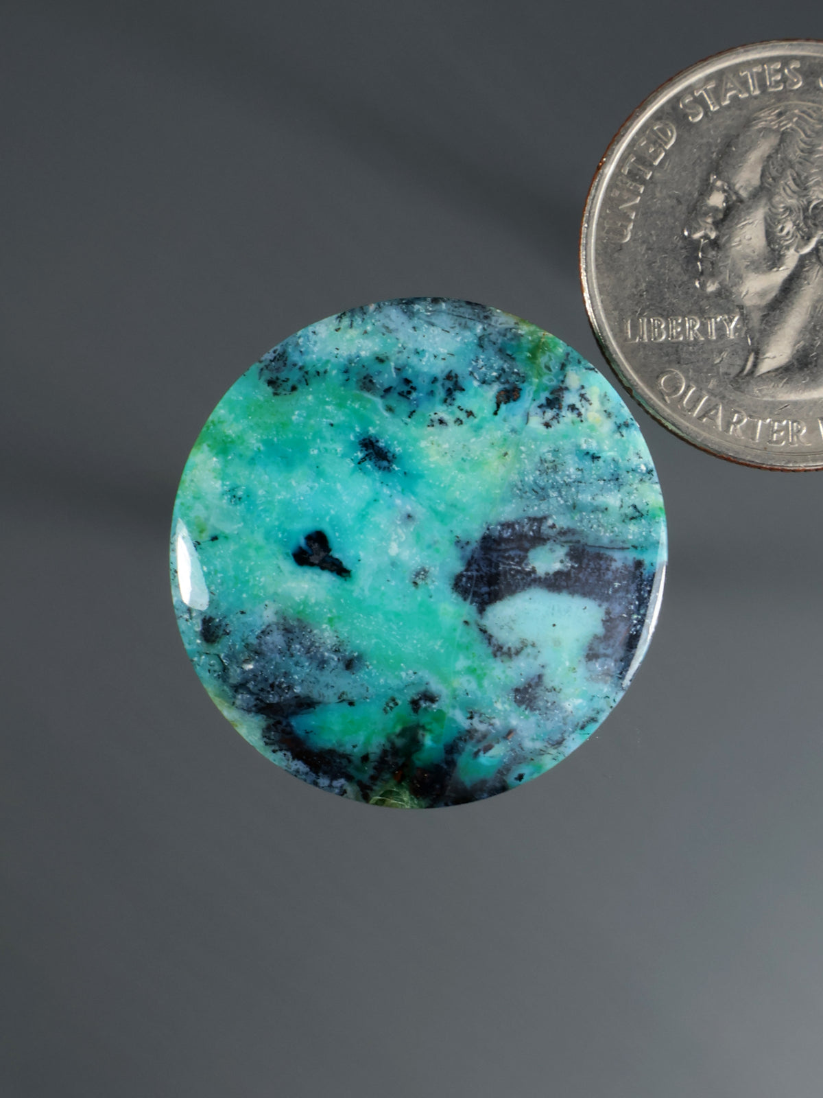 Round turquoise cabochon with black inclusions, polished gemstone for jewelry setting