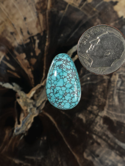 Turquoise teardrop cabochon gemstone with blue matrix webbing